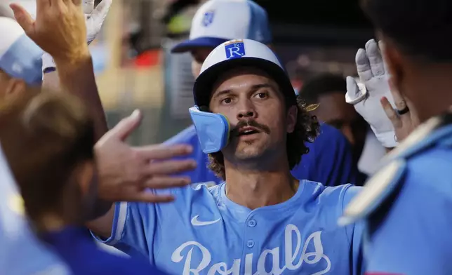 Kansas City Royals' Adam Frazier celebrates after scoring against the Minnesota Twins on a Jonathan India single in the ninth inning of a baseball game Saturday, Aug. 9, 2025, in Minneapolis. (AP Photo/Bruce Kluckhohn)