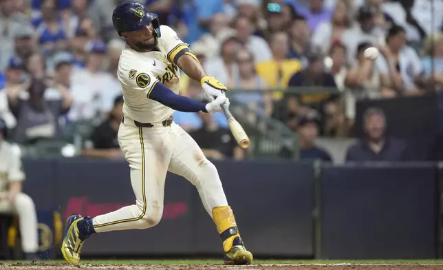 Milwaukee Brewers' Jackson Chourio hits a triple during the fifth inning of a baseball game against the Chicago Cubs, Tuesday, July 29, 2025, in Milwaukee. (AP Photo/Aaron Gash)