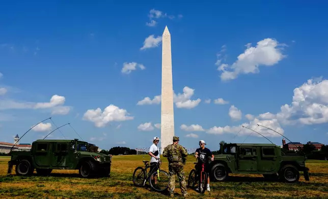 Members of the District of Columbia National Guard patrol along the National Mall, Saturday, Aug. 16, 2025, in Washington. (AP Photo/Julia Demaree Nikhinson)