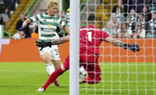 Celtic's Daizen Maeda, left, attempts a shot on goal against Kairat during the UEFA Champions League playoff first leg soccer match at Celtic Park, Wednesday, Aug. 20, 2025, in Glasgow, Scotland. (Andrew Milligan/PA via AP)