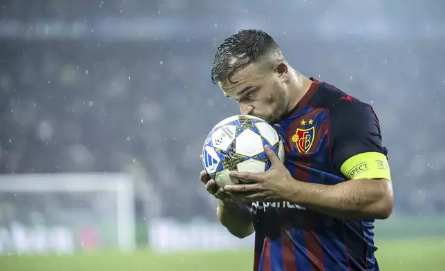 Basel's Xherdan Shaqiri kisses the ball during the UEFA Champions League playoff first leg match between Switzerland's FC Basel 1893 and Denmark's F.C. Copenhagen at the St. Jakob-Park stadium in Basel, Switzerland, on Wednesday, Aug. 20, 2025. (Georgios Kefalas/Keystone via AP)