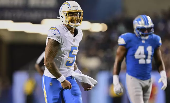Los Angeles Chargers quarterback Trey Lance (5) celebrates his touchdown pass to KeAndre Lambert-Smith in the first half of the Pro Football Hall of Fame NFL preseason game Thursday, July 31, 2025, in Canton, Ohio. (AP Photo/David Dermer)