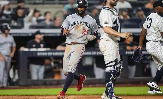 Minnesota Twins' Byron Buxton (25) scores during the sixth inning of a baseball game against the New York Yankees, Wednesday, Aug. 13, 2025, in New York. (AP Photo/Yuki Iwamura)