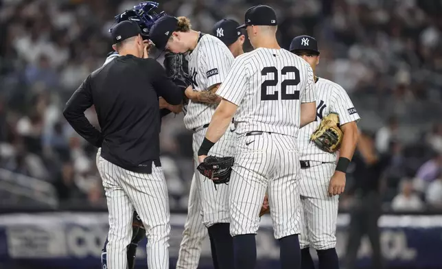 New York Yankees pitcher Cam Schlittler and teammates talk during the fourth inning of a baseball game against the Minnesota Twins, Wednesday, Aug. 13, 2025, in New York. (AP Photo/Yuki Iwamura)