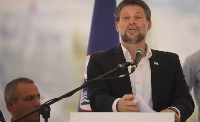 Israeli Finance Minister Bezalel Smotrich speaks to journalists during a press conference about new settlement construction in the Israel-occupied West Bank near Maale Adumim, Wednesday, Aug. 14, 2025. (AP Photo/Ohad Zwigenberg)