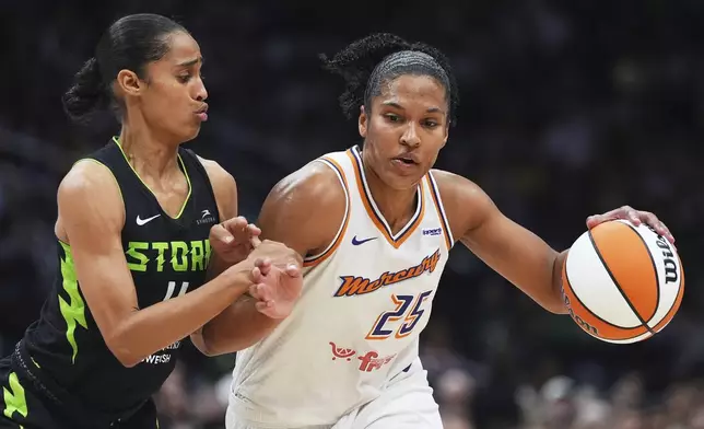 Seattle Storm guard Skylar Diggins, left, defends against Phoenix Mercury forward Alyssa Thomas (25) during the first half of a WNBA basketball game Sunday, Aug. 17, 2025, in Seattle. (AP Photo/Lindsey Wasson)