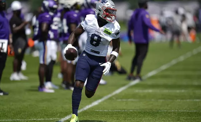 New England Patriots wide receiver Stefon Diggs (8) runs with the football after catching a pass during a joint NFL football training camp with the Minnesota Vikings Wednesday, Aug. 13, 2025, in Eagan, Minn. (AP Photo/Abbie Parr)