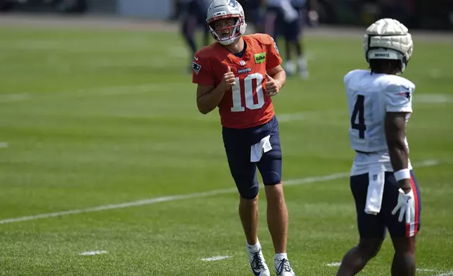 New England Patriots quarterback Drake Maye (10) takes part in drills during a joint NFL football training camp with the Minnesota Vikings Wednesday, Aug. 13, 2025, in Eagan, Minn. (AP Photo/Abbie Parr)
