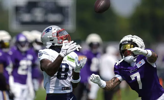 New England Patriots wide receiver Stefon Diggs (8) catches a pass against Minnesota Vikings cornerback Byron Murphy Jr. (7) takes part in drills during a joint NFL football training camp Wednesday, Aug. 13, 2025, in Eagan, Minn. (AP Photo/Abbie Parr)