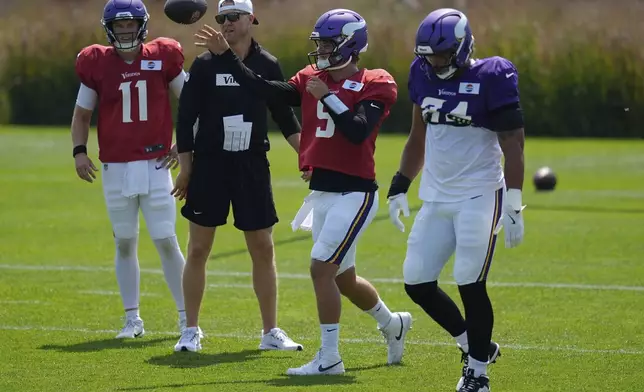 Minnesota Vikings quarterback J.J. McCarthy (9) takes part in drills during a joint NFL football training camp with the New England Patriots, Wednesday, Aug. 13, 2025, in Eagan, Minn. (AP Photo/Abbie Parr)