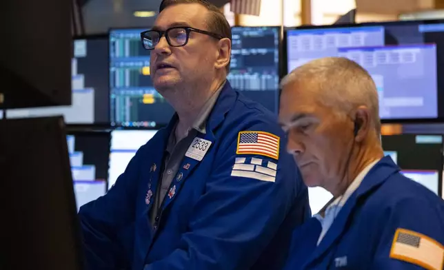 Traders work on the floor of the New York Stock Exchange, Friday, Aug. 1, 2025, in New York. (AP Photo/Yuki Iwamura)