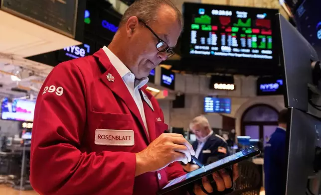 Trader William Lawrence works on the floor of the New York Stock Exchange, Tuesday, July 29, 2025. (AP Photo/Richard Drew)