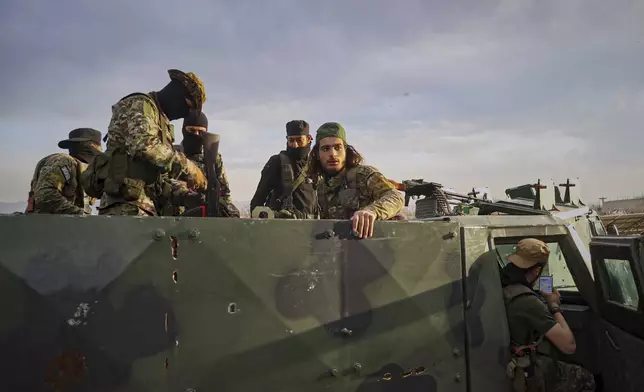 FILE - Syrian troops gather in the village of Hawsh al-Sayyid Ali, located 2 km (1.24 miles) from the Lebanon border, Syria, Monday, March 17, 2025. (AP Photo/Omar Albam, File)