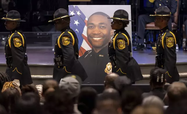 Law enforcement officers march during the funeral of DeKalb County Police Officer David Rose, who was killed while responding to a shooting at the CDC, at First Baptist Church Atlanta, Friday, Aug. 22, 2025, in Atlanta. (Arvin Temkar/Atlanta Journal-Constitution via AP)