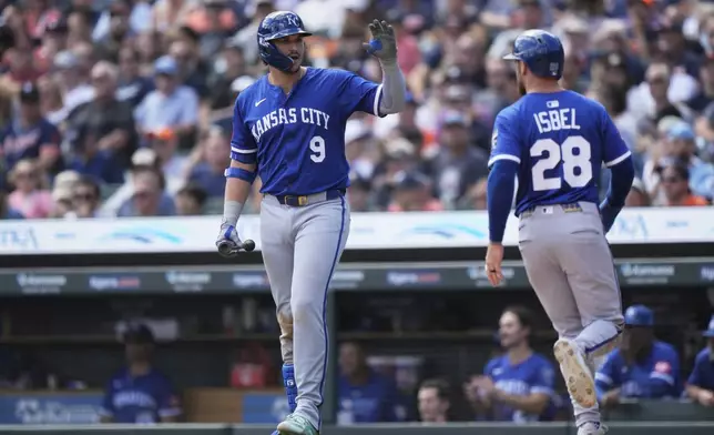 Kansas City Royals' Vinnie Pasquantino, left, celebrates with Kyle Isbel, who scored off a wild pitch by Detroit Tigers relief pitcher Tyler Holton, during the sixth inning of a baseball game Sunday, Aug. 24, 2025, in Detroit. (AP Photo/Ryan Sun)