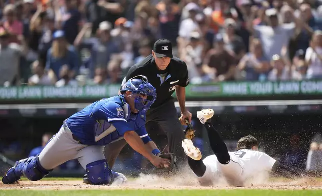 Detroit Tigers' Zach McKinstry, right, slides past Kansas City Royals catcher Luke Maile to score off of a double hit by Jahmai Jones during the fourth inning of a baseball game Sunday, Aug. 24, 2025, in Detroit. (AP Photo/Ryan Sun)