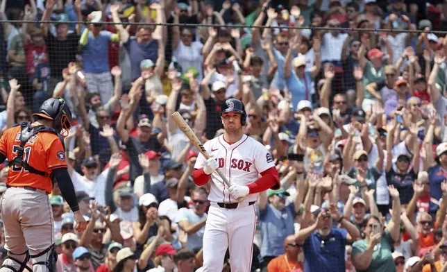 Fans watch behind Boston Red Sox batter Alex Bregman during a baseball game against the Houston Astros, Sunday, Aug. 3, 2025, in Boston (AP Photo/Jim Davis)