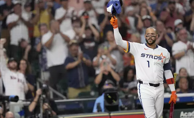 Houston Astros' Carlos Correa acknowledges the crowd as he come up to bat against the Boston Red Sox during the first inning of a baseball game Monday, Aug. 11, 2025, in Houston. (AP Photo/David J. Phillip)