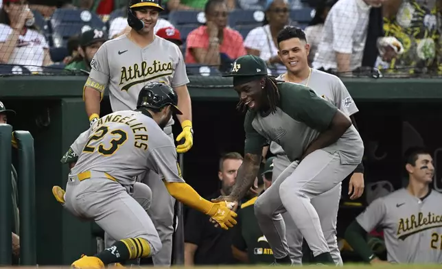 Athletics' Shea Langeliers (23) is greeted by Lawrence Butler, right, after hitting a home run against Washington Nationals pitcher MacKenzie Gore during the first inning of a baseball game in Washington, Tuesday, Aug. 5, 2025. (AP Photo/Terrance Williams)