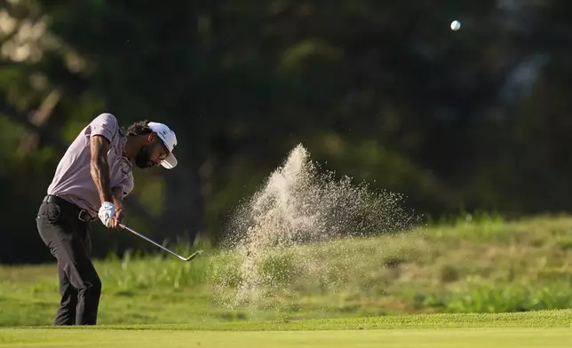 Akshay Bhatia hits out of the bunker on the second hole during the first round of the St. Jude Championship golf tournament Thursday, Aug. 7, 2025, in Memphis, Tenn. (AP Photo/George Walker IV)