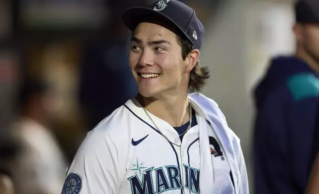 Seattle Mariners starting pitcher Bryan Woo in the dugout after working against the Chicago White Sox during the seventh inning of a baseball game, Tuesday, Aug. 5, 2025, in Seattle. (AP Photo/John Froschauer)