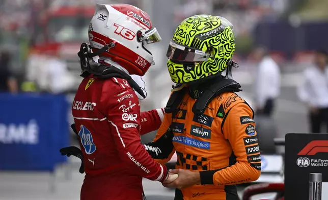 McLaren driver Lando Norris of Britain, right, congratulates Ferrari driver Charles Leclerc of Monaco for his pole position after the qualifying session for the Hungarian Formula One Grand Prix at the Hungaroring racetrack in Mogyorod, Hungary, Saturday, Aug. 2, 2025. (AP Photo/Denes Erdos)