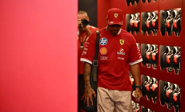 Ferrari driver Lewis Hamilton of the United Kingdom walks through the paddock at the Hungaroring racetrack, in Mogyoród, Hungary, Thursday, July 31, 2025, ahead of the Hungarian Formula One Grand Prix. (AP Photo/Denes Erdos)