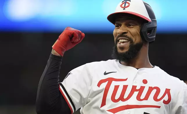 Minnesota Twins' Byron Buxton (25) reacts after hitting a single during the third inning of a baseball game against the Detroit Tigers Thursday, Aug. 14, 2025, in Minneapolis. (AP Photo/Abbie Parr)