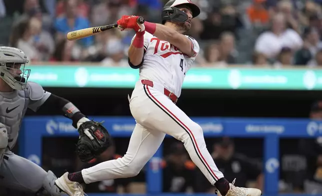 Minnesota Twins' Edouard Julien (47) watches his solo home run during third inning of a baseball game against the Detroit Tigers Thursday, Aug. 14, 2025, in Minneapolis. (AP Photo/Abbie Parr)