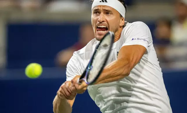 Alexander Zverev of Germany hits a backhand return to Francisco Cerundolo of Argentina during their match at the National Bank Open in Toronto, Saturday, Aug. 2, 2025. (Frank Gunn/The Canadian Press via AP)
