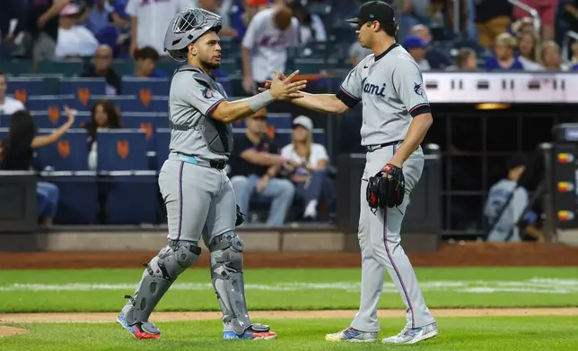 Miami Marlins catcher Agustín Ramírez (50) and pitcher Tyler Phillips celebrate after defeating the New York Mets, Saturday, Aug. 30, 2025, in New York. (AP Photo/Noah K. Murray)