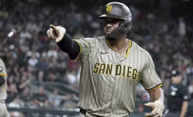 San Diego Padres' Xander Bogaerts reacts after hitting a solo home run against the Arizona Diamondbacks in the seventh inning during a baseball game, Wednesday, Aug 6, 2025, in Phoenix. (AP Photo/Rick Scuteri)
