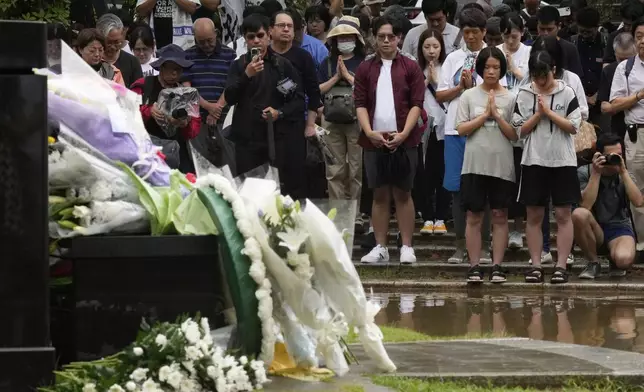 People offer prayers at the Atomic Bomb Hypocenter Park, during a ceremony to commemorate the 80th anniversary of the day an atomic bomb was dropped on Japanese southwestern city, in Nagasaki, Japan Saturday, Aug. 9, 2025.(AP Photo/Eugene Hoshiko)