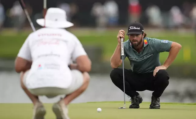 Cameron Young lines up his putt on the 15th green during the third round of the Tour Championship golf tournament, Saturday, Aug. 23, 2025, in Atlanta. (AP Photo/Mike Stewart)