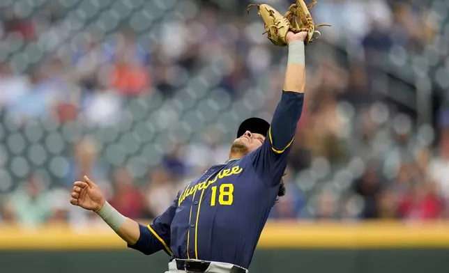 Milwaukee Brewers second baseman Anthony Seigler (18) makes the catch against Atlanta Braves' Michael Harris II in the first inning of a baseball game, Monday, Aug. 4, 2025, in Atlanta. (AP Photo/Mike Stewart)