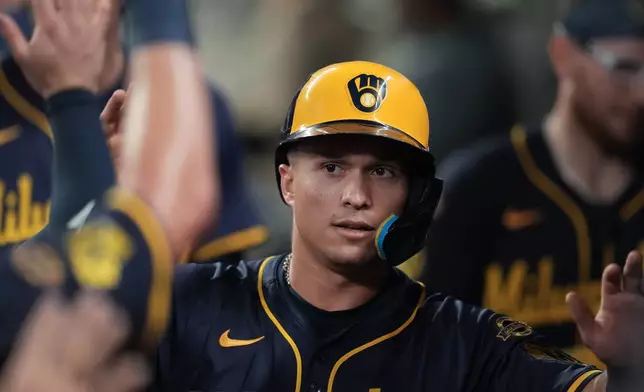 Milwaukee Brewers' Isaac Collins (6) celebrates scoring off the bat of Brice Turang in the sixth inning of a baseball game against the Atlanta Braves, Tuesday, Aug. 5, 2025, in Atlanta. (AP Photo/Mike Stewart)