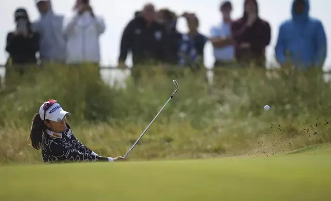 A Lim Kim of South Korea plays out of the bunker on the 4th hole during the final round of the Women's British Open golf championship, at Royal Porthcawl Golf Club in Porthcawl, Wales, Sunday, Aug. 3, 2025. (AP Photo/Kin Cheung)