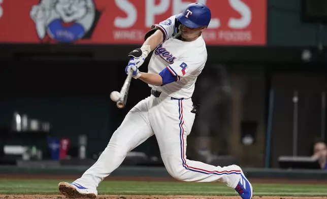 Texas Rangers' Corey Seager connects for a solo home run in the seventh inning of a baseball game against the Los Angeles Angels, Tuesday, Aug. 26, 2025, in Arlington, Texas. (AP Photo/Tony Gutierrez)