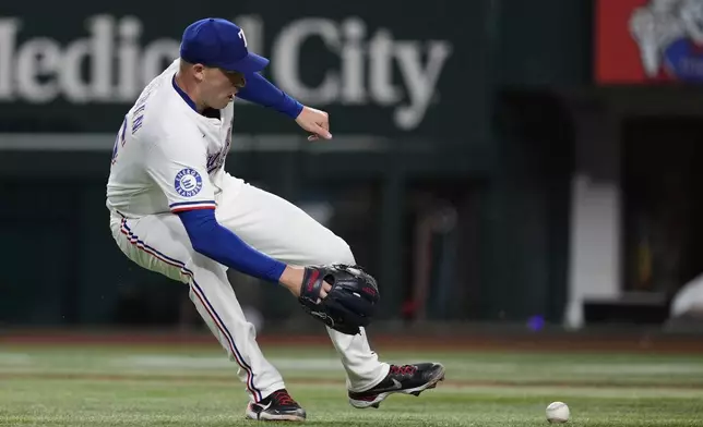 Texas Rangers starting pitcher Patrick Corbin fields a ground out by Los Angeles Angels' Luis Rengifo in the fourth inning of a baseball game, Tuesday, Aug. 26, 2025, in Arlington, Texas. (AP Photo/Tony Gutierrez)