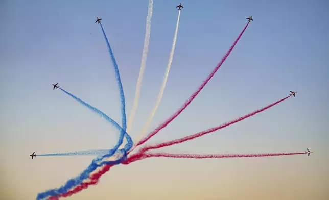 Pilots of the Patrouille de France (PAF), the precision aerobatics unit of the French Air and Space Force, perform above the runway of the Aurel Vlaicu airport, on the first day of the Bucharest International Air Show, BIAS 2025 in Bucharest, Romania, Saturday, Aug. 30, 2025. (AP Photo/Andreea Alexandru)
