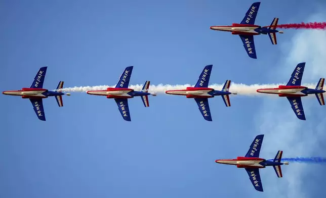 Pilots of the Patrouille de France (PAF), the precision aerobatics unit of the French Air and Space Force, perform above the runway of the Aurel Vlaicu airport, on the first day of the Bucharest International Air Show, BIAS 2025 in Bucharest, Romania, Saturday, Aug. 30, 2025. (AP Photo/Andreea Alexandru)