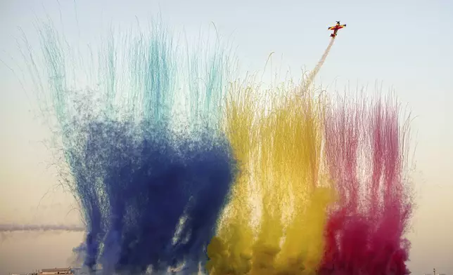 Pilots of the Hawks of Romania aerobatic team perform above the runway of the Aurel Vlaicu airport, as pyrotechnics go off on the first day of the Bucharest International Air Show, BIAS 2025 in Bucharest, Romania, Saturday, Aug. 30, 2025. (AP Photo/Andreea Alexandru)
