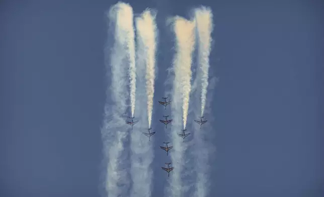 Pilots of the Patrouille de France (PAF), the precision aerobatics unit of the French Air and Space Force, perform above the runway of the Aurel Vlaicu airport, on the first day of the Bucharest International Air Show, BIAS 2025 in Bucharest, Romania, Saturday, Aug. 30, 2025. (AP Photo/Andreea Alexandru)