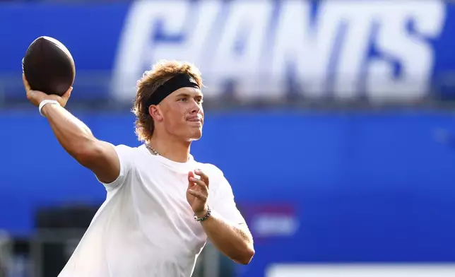 New York Giants quarterback Jaxson Dart warms up before a preseason NFL football game against the New York Jets in East Rutherford, N.J., Saturday, Aug. 16, 2025. (AP Photo/Noah K. Murray)