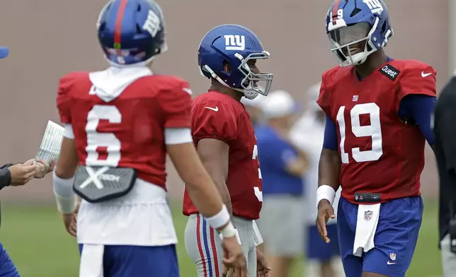 New York Giants quarterback Jameis Winston (19) reacts with Russell Wilson in front of Jaxson Dart (6) during Back Together Weekend at the team's NFL football training camp, Sunday, July 27, 2025, in East Rutherford, N.J. (AP Photo/Adam Hunger)
