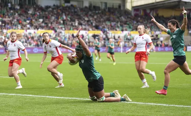 Ireland's Grace Moore scores their fifth try during the Women's Rugby World Cup 2025 Pool C match between Ireland and Spain at Franklin's Gardens, Northampton, England, Sunday Aug. 31, 2025. (Joe Giddens/PA via AP)