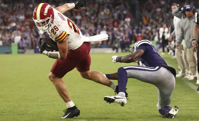 ADDS PLAY WAS OVERTURNED BY REVIEW - Iowa State Carson Hansen breaks a tackle on his way to the endzone that was ruled a touchdown and later overturned by review during an NCAA college football game between Iowa State and Kansas State in Dublin, Ireland Saturday, Aug. 23, 2025. (AP Photo/Peter Morrison)