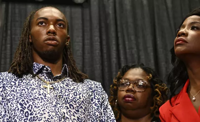 William McNeil Jr., left, along with his mother Latoya Solomon, center, and attorney Sue-Ann Robinson, right, look on during a press conference Tuesday, July 29, 2025, in Chicago. (AP Photo/Paul Beaty)