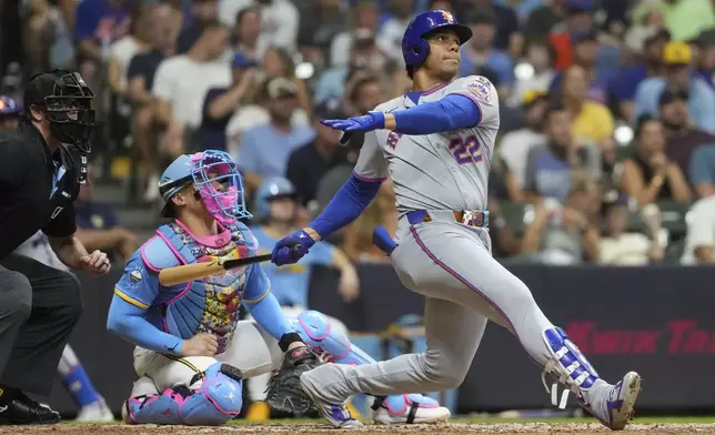 New York Mets' Juan Soto, right, watches his solo home run during the fifth inning of a baseball game against the Milwaukee Brewers, Saturday, Aug. 9, 2025, in Milwaukee. (AP Photo/Aaron Gash)
