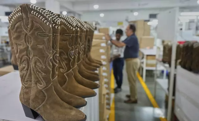 High ankle boots for women for export are kept for packing at Dawar leather footwear manufacturing unit in Agra, India, Monday, Aug. 25, 2025. (AP Photo/Manish Swarup)